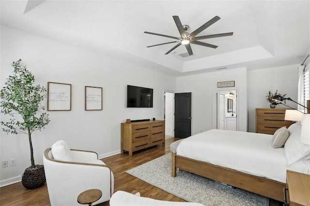 2908 Lee Shore Loop, Orlando, FL 32820 - bedroom with a raised ceiling, baseboards, wood finished floors, ensuite bathroom, and a ceiling fan
