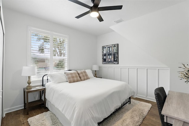 2908 Lee Shore Loop, Orlando, FL 32820 - bedroom with dark wood-type flooring, a wainscoted wall, and ceiling fan