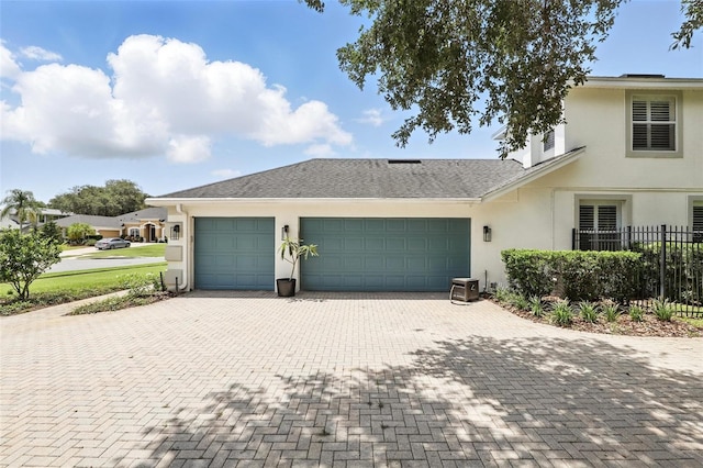 2908 Lee Shore Loop, Orlando, FL 32820 - view of front of house with stucco siding, an attached garage, and decorative driveway