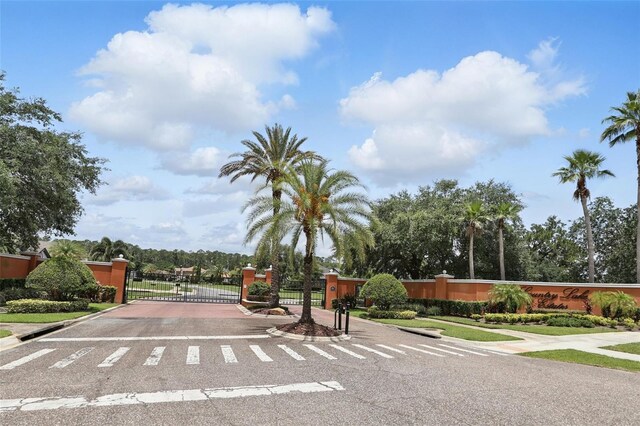 2908 Lee Shore Loop, Orlando, FL 32820 - view of asphalt road featuring a gate, curbs, sidewalks, and a gated entry