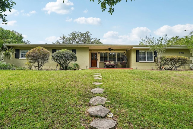 3312 SE 6th St, Ocala, FL 34471 - view of front facade featuring stucco siding, a front yard, a ceiling fan, and a patio