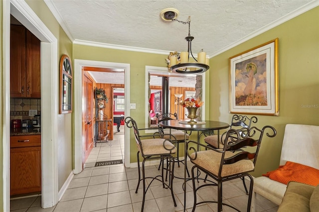 3312 SE 6th St, Ocala, FL 34471 - dining area with light tile patterned flooring, a textured ceiling, ornamental molding, and baseboards
