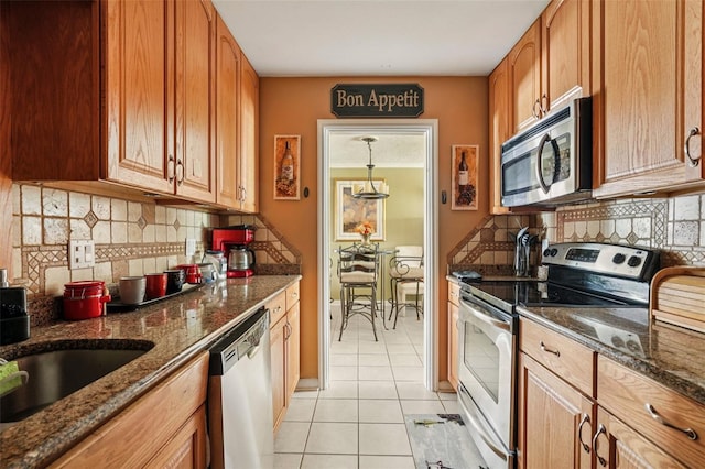 3312 SE 6th St, Ocala, FL 34471 - kitchen featuring stainless steel appliances, light tile patterned flooring, dark stone counters, and decorative backsplash
