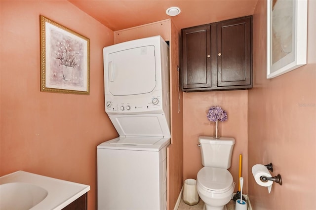 3312 SE 6th St, Ocala, FL 34471 - bathroom with stacked washer and clothes dryer, toilet, and vanity