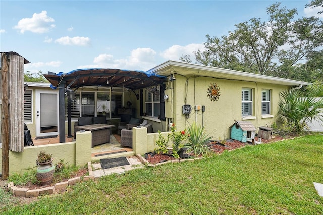 3312 SE 6th St, Ocala, FL 34471 - rear view of property featuring an outdoor living space, stucco siding, a lawn, a pergola, and a patio area