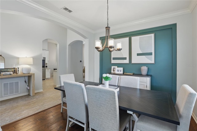 405 Courtlea Park Dr, Winter Garden, FL 34787 - dining space with a chandelier, arched walkways, crown molding, hardwood / wood-style floors, and baseboards