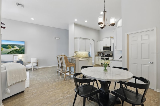 405 Courtlea Park Dr, Winter Garden, FL 34787 - dining space featuring a high ceiling, a chandelier, recessed lighting, baseboards, and light wood finished floors