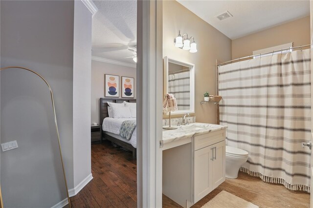 405 Courtlea Park Dr, Winter Garden, FL 34787 - ensuite bathroom with vanity, toilet, ceiling fan, crown molding, and wood finished floors