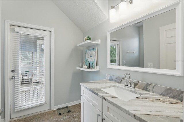 405 Courtlea Park Dr, Winter Garden, FL 34787 - bathroom with lofted ceiling, vanity, and baseboards