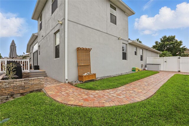 405 Courtlea Park Dr, Winter Garden, FL 34787 - view of property exterior with a gate, stucco siding, and a patio