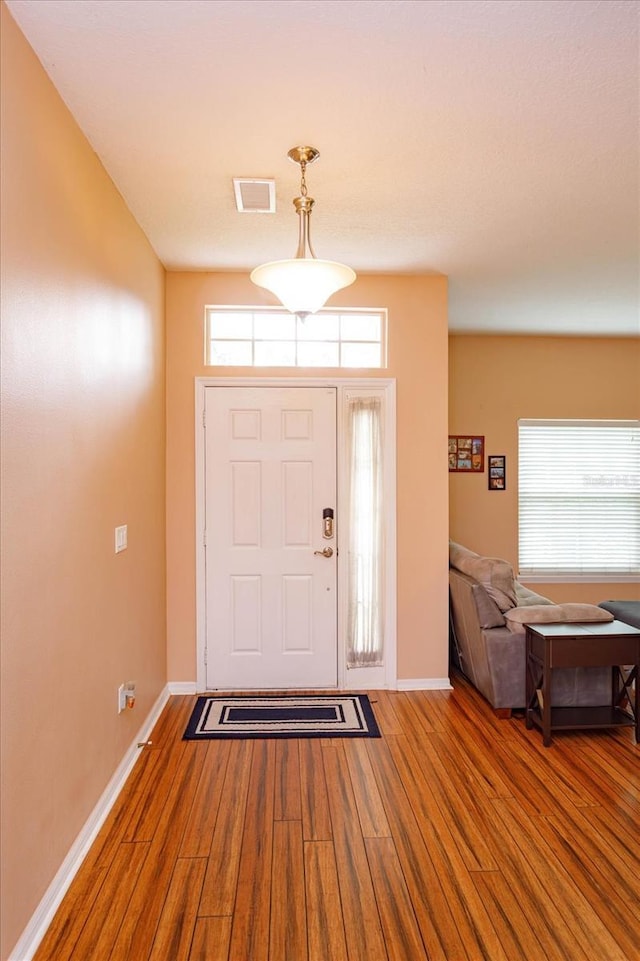 4642 Waterside Pointe Cir, Orlando, FL 32829 - entrance foyer featuring wood finished floors and baseboards