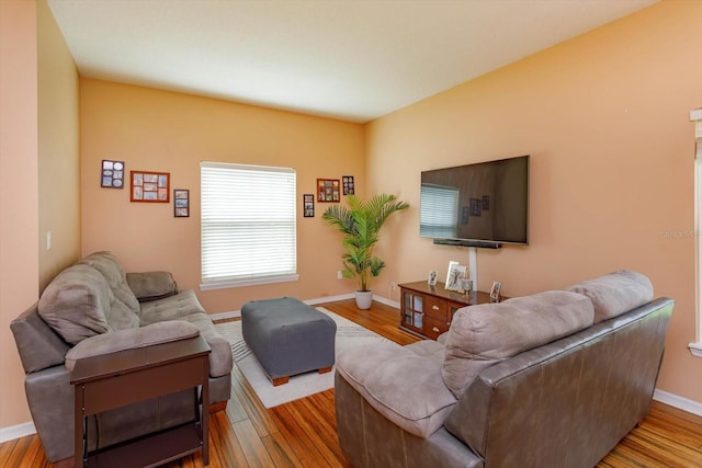 4642 Waterside Pointe Cir, Orlando, FL 32829 - living room featuring baseboards and wood finished floors