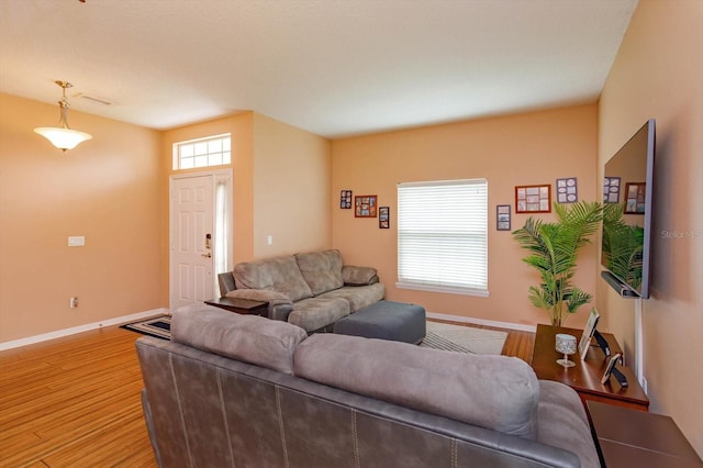 4642 Waterside Pointe Cir, Orlando, FL 32829 - living area featuring light wood-type flooring and baseboards