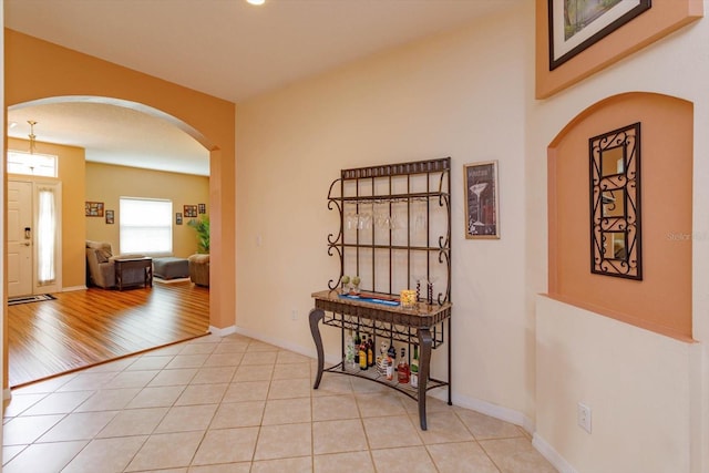 4642 Waterside Pointe Cir, Orlando, FL 32829 - tiled entrance foyer with arched walkways and baseboards