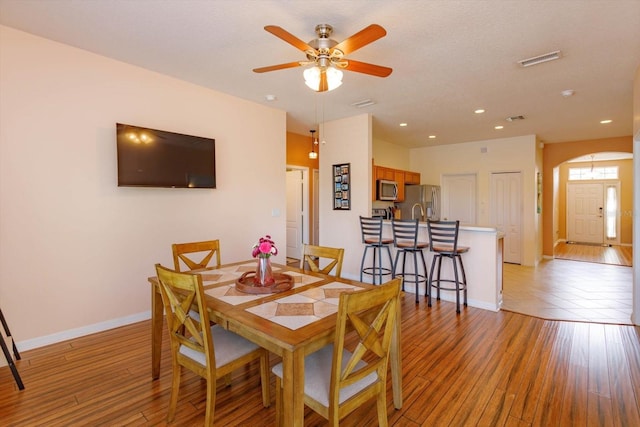4642 Waterside Pointe Cir, Orlando, FL 32829 - dining room with light wood-style floors, baseboards, ceiling fan, and recessed lighting