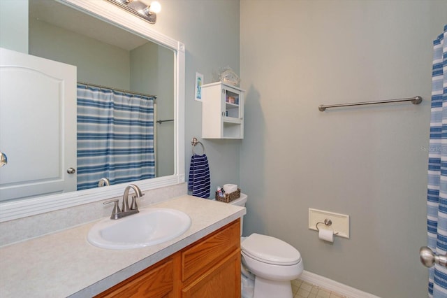 4642 Waterside Pointe Cir, Orlando, FL 32829 - bathroom featuring vanity, toilet, tile patterned flooring, a shower with shower curtain, and baseboards
