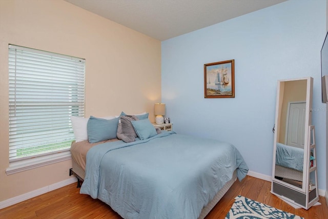 4642 Waterside Pointe Cir, Orlando, FL 32829 - bedroom featuring baseboards and wood finished floors
