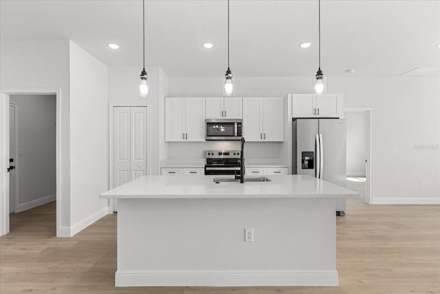 14915 SW 39th Cir, Ocala, FL 34473 - kitchen with appliances with stainless steel finishes, a sink, baseboards, white cabinets, and light wood-style floors