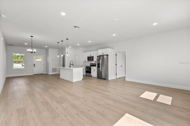 14915 SW 39th Cir, Ocala, FL 34473 - unfurnished living room with a chandelier, recessed lighting, a sink, baseboards, and light wood finished floors