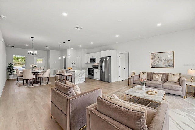 14915 SW 39th Cir, Ocala, FL 34473 - living room with recessed lighting, light wood-style flooring, and a chandelier