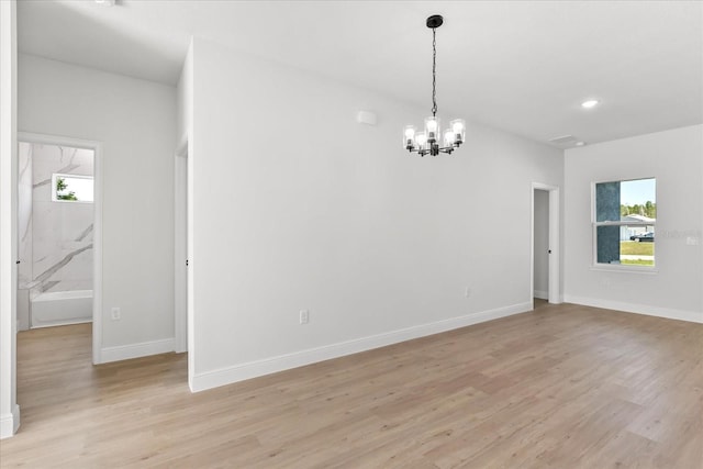 14915 SW 39th Cir, Ocala, FL 34473 - spare room with a chandelier, light wood finished floors, baseboards, and recessed lighting