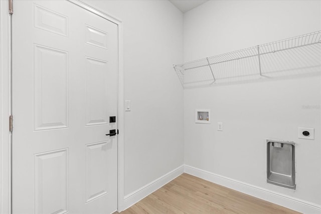 14915 SW 39th Cir, Ocala, FL 34473 - laundry area with hookup for an electric dryer, hookup for a washing machine, baseboards, and light wood finished floors