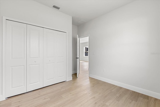 14915 SW 39th Cir, Ocala, FL 34473 - unfurnished bedroom with light wood-type flooring, baseboards, and a closet