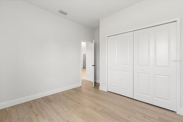 14915 SW 39th Cir, Ocala, FL 34473 - unfurnished bedroom with light wood-style floors, baseboards, and a closet