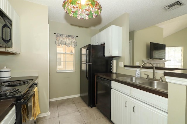 620 Glenwood Ct Unit 79, Altamonte Springs, FL 32714 - kitchen featuring black appliances, a sink, plenty of natural light, dark countertops, and vaulted ceiling