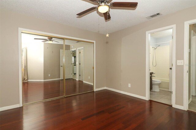 620 Glenwood Ct Unit 79, Altamonte Springs, FL 32714 - unfurnished bedroom with wood finished floors, a closet, a textured ceiling, baseboards, and a ceiling fan