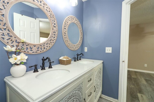 620 Glenwood Ct Unit 79, Altamonte Springs, FL 32714 - bathroom featuring double vanity, baseboards, and wood finished floors