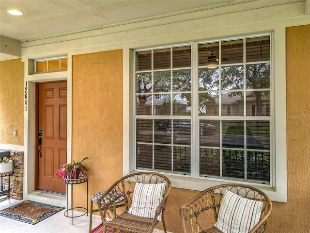 12641 Arley Dr, Windermere, FL 34786 - view of exterior entry with covered porch and stucco siding