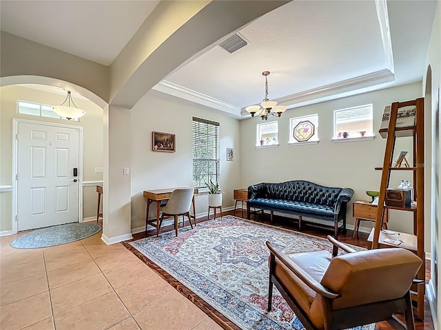 12641 Arley Dr, Windermere, FL 34786 - living area with a raised ceiling, arched walkways, a chandelier, light tile patterned floors, and baseboards