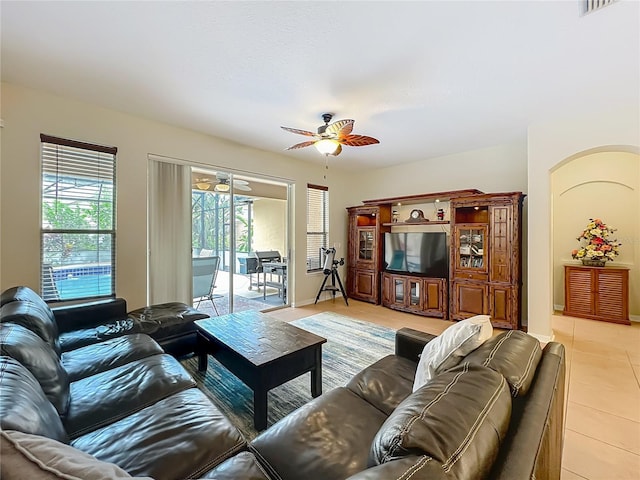 12641 Arley Dr, Windermere, FL 34786 - living area with ceiling fan, light tile patterned flooring, and arched walkways