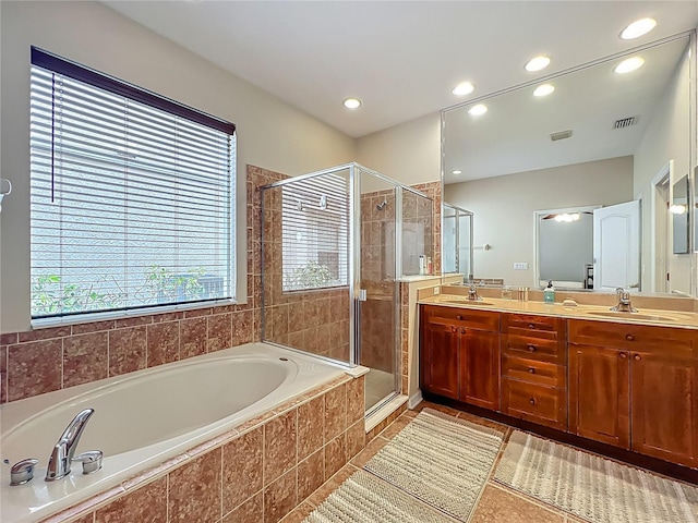 12641 Arley Dr, Windermere, FL 34786 - bathroom featuring a garden tub, a stall shower, double vanity, healthy amount of natural light, and recessed lighting