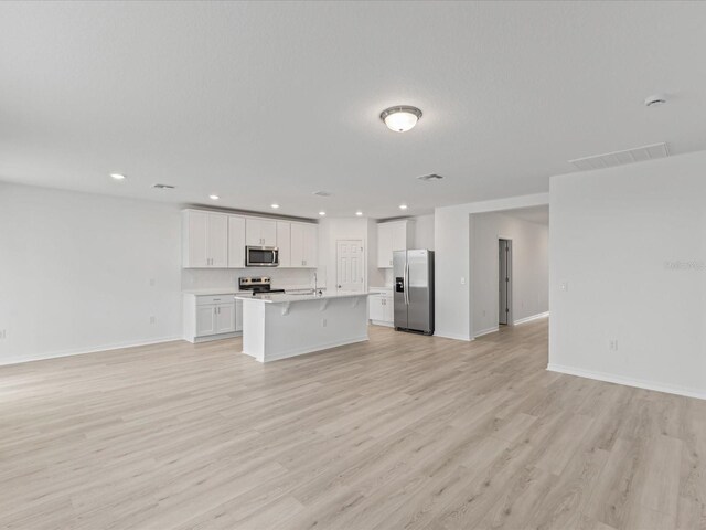 1345 Griffon Ave, Lake Alfred, FL 33850 - kitchen featuring stainless steel appliances, open floor plan, white cabinets, and recessed lighting