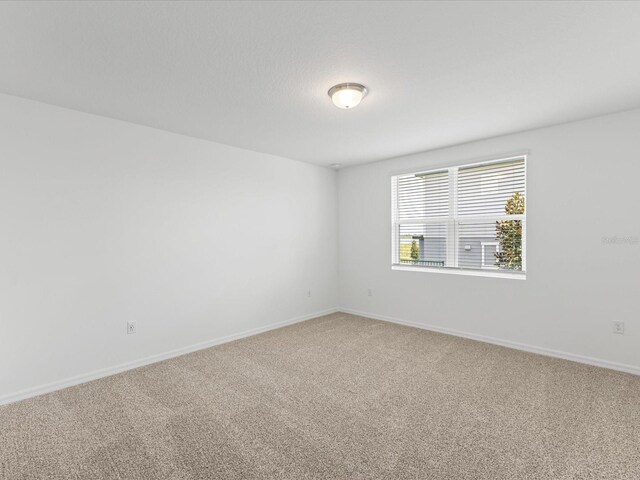 1345 Griffon Ave, Lake Alfred, FL 33850 - spare room with light colored carpet and baseboards
