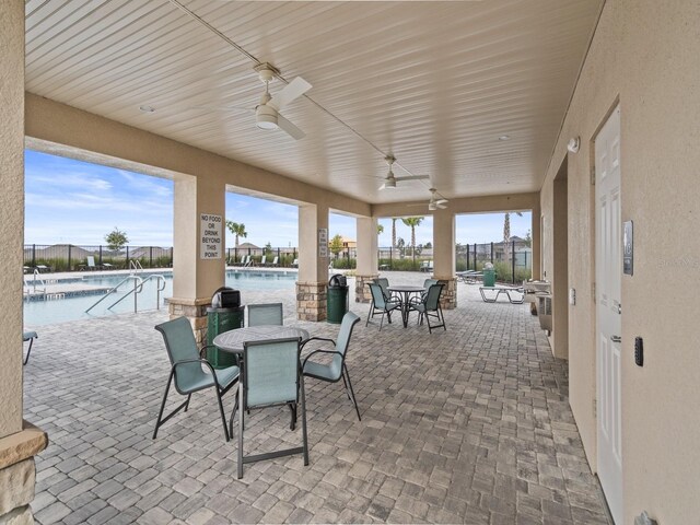 1345 Griffon Ave, Lake Alfred, FL 33850 - view of patio / terrace with ceiling fan, a community pool, and outdoor dining space