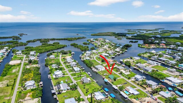 24277 Treasure Island Blvd, Punta Gorda, FL 33955 - aerial view of property and surrounding area featuring a large body of water and nearby suburban area