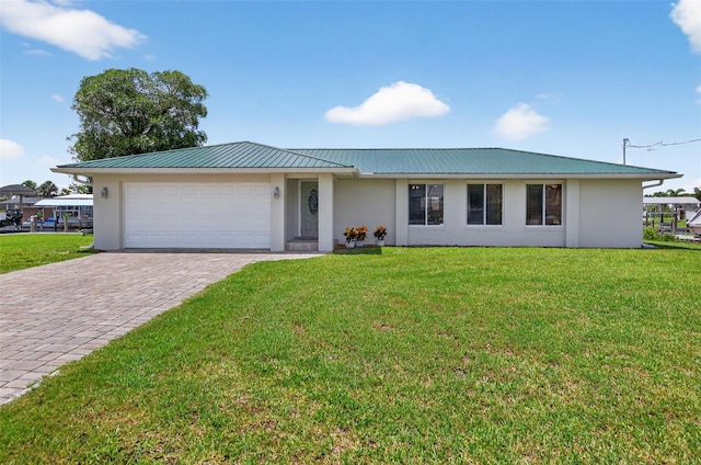 24277 Treasure Island Blvd, Punta Gorda, FL 33955 - ranch-style house with stucco siding, a garage, decorative driveway, a metal roof, and a front lawn
