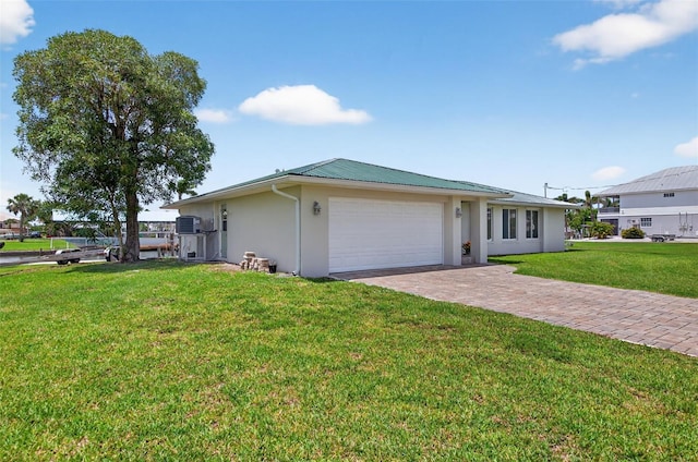 24277 Treasure Island Blvd, Punta Gorda, FL 33955 - view of front of property with stucco siding, a garage, a front yard, decorative driveway, and a metal roof