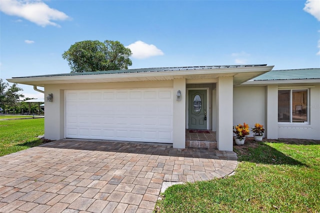 24277 Treasure Island Blvd, Punta Gorda, FL 33955 - view of front of home featuring stucco siding, a metal roof, decorative driveway, and a front yard