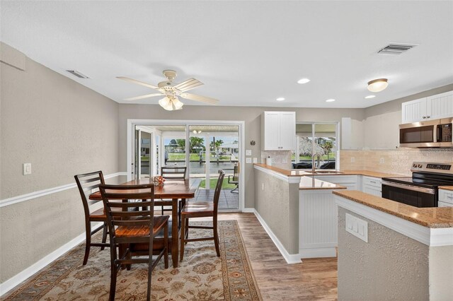 24277 Treasure Island Blvd, Punta Gorda, FL 33955 - dining area with plenty of natural light, light wood finished floors, a ceiling fan, recessed lighting, and a textured wall