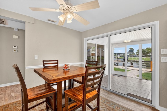 24277 Treasure Island Blvd, Punta Gorda, FL 33955 - dining room with light wood-type flooring, a water view, and ceiling fan