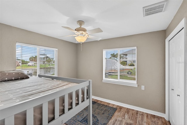 24277 Treasure Island Blvd, Punta Gorda, FL 33955 - bedroom with multiple windows, wood finished floors, a closet, and a ceiling fan