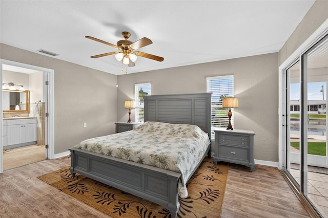24277 Treasure Island Blvd, Punta Gorda, FL 33955 - bedroom with access to outside, light wood-style flooring, ensuite bathroom, and a ceiling fan