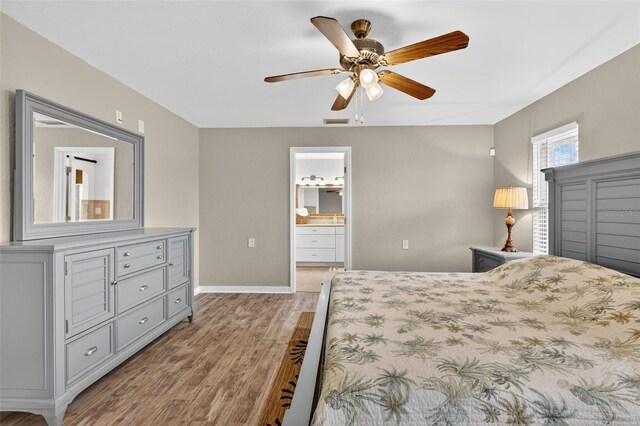 24277 Treasure Island Blvd, Punta Gorda, FL 33955 - bedroom with light wood finished floors, a ceiling fan, and ensuite bath