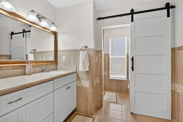 24277 Treasure Island Blvd, Punta Gorda, FL 33955 - bathroom featuring vanity, tile patterned flooring, a wainscoted wall, and tile walls