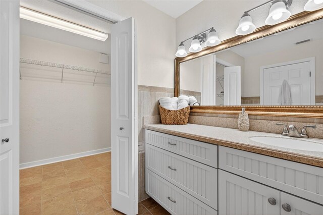 24277 Treasure Island Blvd, Punta Gorda, FL 33955 - full bathroom featuring vanity, a spacious closet, and tile patterned floors