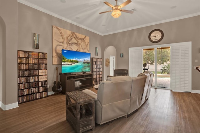 2313 Pesaro Cir, Ocoee, FL 34761 - living room featuring arched walkways, wood finished floors, baseboards, ceiling fan, and ornamental molding